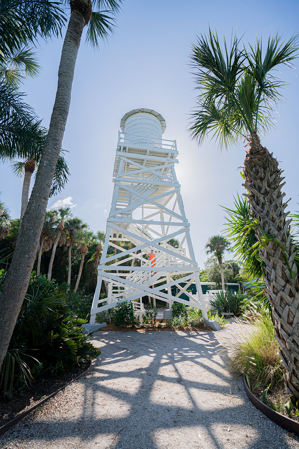 The cabbage key water tower is white, tall, and surrounded by palm trees. This is one of the best things to do near Fort Myers, Florida.