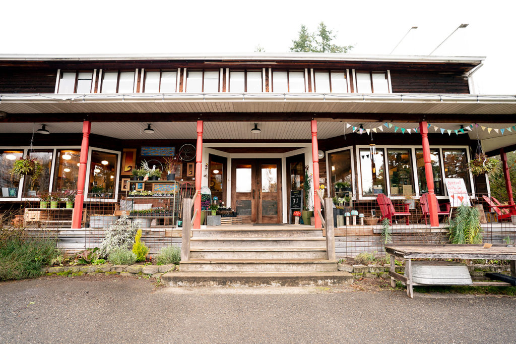 The storefront of Country Store & Farm on Vashon Island. It's a brown building with a porch.