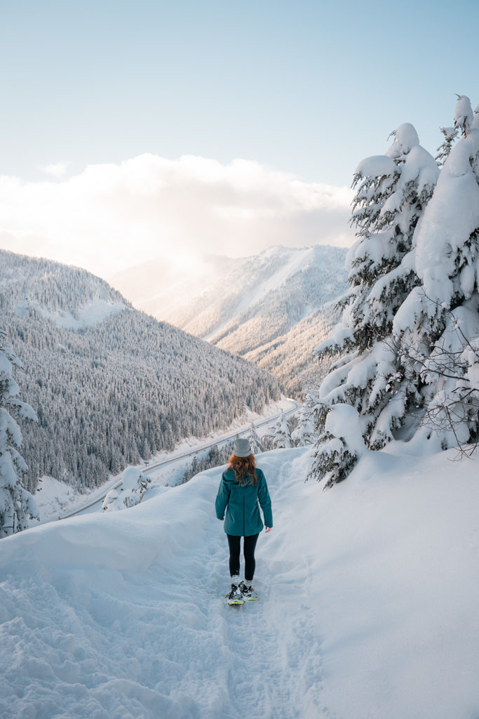 Woman snowshoeing on trail