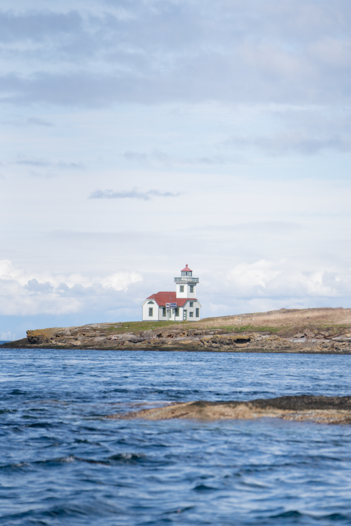 A red and white lighthouse perched on a peninsula near Orcas Island