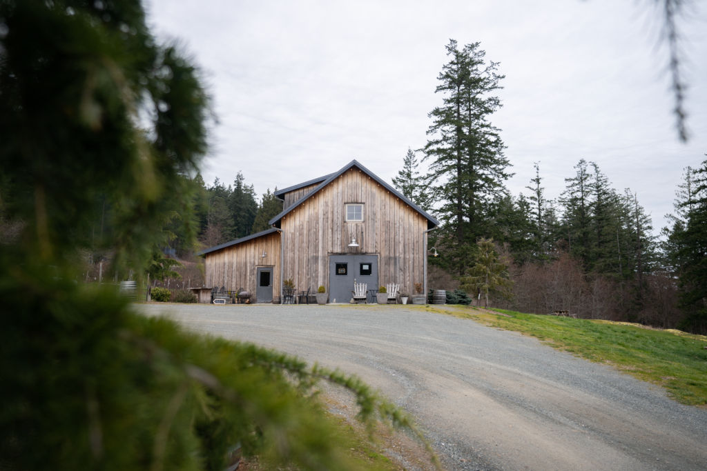 Orcas island winery is a barn perched on a hill surrounded by green trees